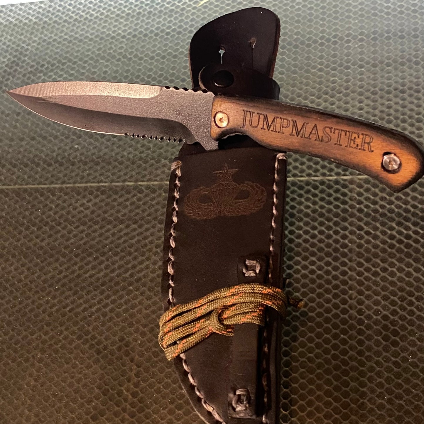 The Jumpmaster knife was developed for use by military jumpmaster personnel as an emergency cutting tool. This knife is custom made; you won't find any other knife like it. It measures in at 10 inches total length with a 6-inch blade. Designed to be lightweight, stylish and effective. Each knife is custom made